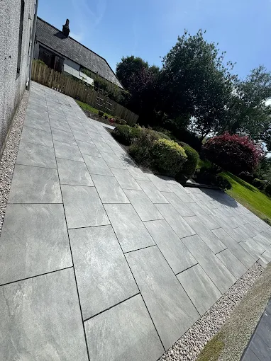 Grey porcelain patio installed by JM Driveways & Paving Ltd